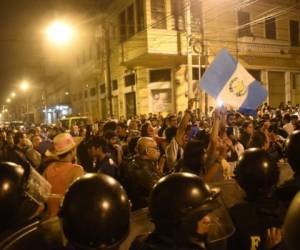 People take part in a protest demanding the resignation of congressmen outside the Guatemalan National Congress, in Guatemala City on September 16, 2017.Guatemala's congress early this week voted overwhelmingly to reject a UN-backed request to lift the immunity of President Jimmy Morales in order for him to face a corruption probe over irregular party financing. / AFP PHOTO / JOHAN ORDONEZ