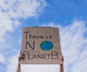 Group of demonstrators on road. Activists protesting on social issues. Race fight and climate change protesting activist during lockdown. global warming and environmental issues. Activists protesting on the street. Group of protestors race fight climate change social issues. Global warming and environment concept - Focus on banners - Group of demonstrators on the road with fist and hands in the air.