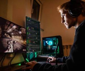 Teenage Boy Playing Multiplayer Games on Desktop Pc in his Dark Room