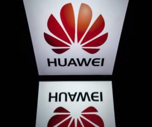 A picture taken on February 4, 2019 shows the Huawei logo displayed on a tablet in Paris. - A government amendment to establish a pre-authorization for the operation of telecom networks, with a view to deploy 5G, received on February 4, 2019 an 'unfavorable opinion' from the special commission charged with examining the draft law Pact. (Photo by Lionel BONAVENTURE / AFP)
