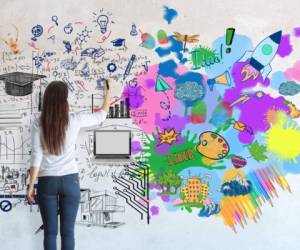 Creative and analytical thinking concept. Back view of young casual girl drawing abstract sketch