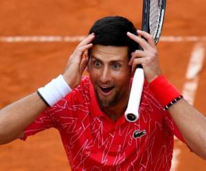 Serbia's Novak Djokovic reacts as he takes part in tennis match during a charity exhibition hosted by him, in Belgrade on June 12, 2020. - Novak Djokovic has also tested positive for coronavirus on June 23, 2020 along with Grigor Dimitrov, Borna Coric and Viktor Troicki, after taking part in an exhibition tennis tournament in the Balkans featuring world number one Novak Djokovic, raising questions over the sport's planned return in August. (Photo by Andrej ISAKOVIC / AFP)