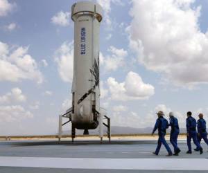 VAN HORN, TEXAS - JULY 20: Blue Origin’s New Shepard crew (L-R) Jeff Bezos, Wally Funk, Oliver Daemen, and Mark Bezos walk near the booster to pose for a picture after flying into space in the Blue Origin New Shepard rocket on July 20, 2021 in Van Horn, Texas. Mr. Bezos and the crew were the first human spaceflight for the company. (Photo by Joe Raedle/Getty Images)