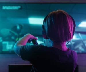 Little boy playing video game in the dark room