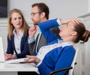 Young female professional doesn’t agree with the opinion of her colleagues on a business meeting