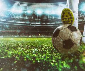 Football scene at night match with player ready to shoot the ball