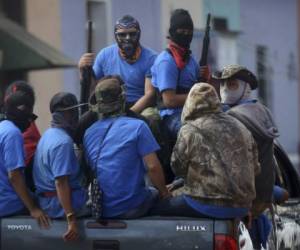 Paramilitaries are seen on trucks at Monimbo neighborhood in Masaya, Nicaragua, on July 18, 2018, following clashes with anti-government demonstrators.The head of the Inter-American Commission on Human Rights has described as 'alarming' the ongoing violence in Nicaragua, where months of clashes between protesters and the forces of President Daniel Ortega have claimed almost 300 lives. / AFP PHOTO / MARVIN RECINOS