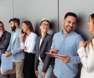 Business people discussing over documents in modern office lobby.