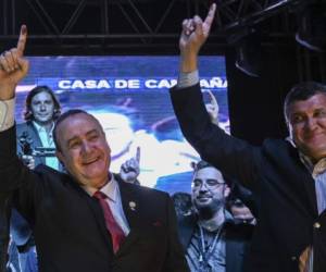 Guatemalan presidential candidate for the Vamos (Let's Go) party, Alejandro Giammattei (L), and his running mate Guillermo Castillo celebrate at the party headquarters in Guatemala City on August 11, 2019 after the run-off presidential election. - Giammattei declared victory in Sunday's run-off election in Guatemala, holding a major lead with the results from more than 90 percent of polling stations counted. (Photo by Johan ORDONEZ / AFP)