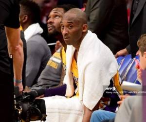 (FILES) In this file photo Kobe Bryant #24 of the Los Angeles Lakers looks on from the bench late in the fourth quarter against the Utah Jazz at Staples Center on April 13, 2016 in Los Angeles, California. - The towel that Kobe Bryant wore over his shoulders during his farewell speech after his final National Basketball League game has fetched over $33,000 at auction, the US media said on March 29, 2020.With the towel draped around him to help mop up his sweat, the Los Angeles Lakers superstar closed his speech with his signature phrase, 'Mamba Out.'The towel ended up in the hands of a fan as Bryant walked off the court and was then sold several times before the latest online auction. (Photo by Harry How / GETTY IMAGES NORTH AMERICA / AFP)