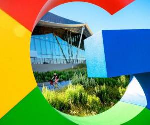 A bicyclist rides along a path at Google’s Bay View campus in Mountain View, California on June 27, 2022. (Photo by NOAH BERGER / AFP)