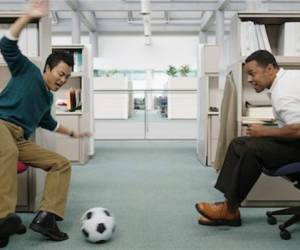 619-00545520Model Release: YesProperty Release: YesTwo businessmen playing soccer in office