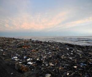 Una playa llena de residuos plásticos y otros desechos se ve en Omoa, Honduras, el 11 de septiembre de 2022. Lo mismo sucede en las paradisíacas playas del Caribe hondureño, que reciben miles de toneladas de desechos de Guatemala. FOTO ORLANDO SIERRA / AFP