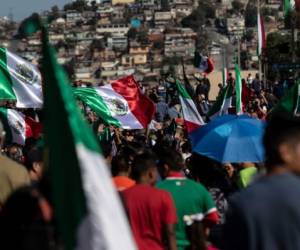 Local residents hold a demonstration against the Central American migrants moving towards the United States and passing and staying in Tijuana, on November 18, 2018, in Tijuana, Baja California, Mexico. - The Central American migrant caravan trekking toward the United States converged on the US-Mexican border Thursday after more than a month on the road, undeterred by President Donald Trump's deployment of thousands of American troops near the border. (Photo by Guillermo Arias / AFP)