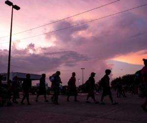 Migrants who were part of a caravan heading north stop to rest in Huixtla, Chiapas state, Mexico, Sunday, Sept. 5, 2021. (AP Photo/Marco Ugarte)