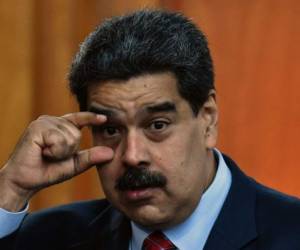 Venezuelan President Nicolas Maduro leaves after offering a press conference in Caracas, on January 25, 2019. - Venezuela's opposition leader Juan Guaido called Friday for a 'major demonstration' next week to demand the resignation of President Nicolas Maduro, in his first public appearance since declaring himself 'acting president' two days ago. (Photo by Yuri CORTEZ / AFP)