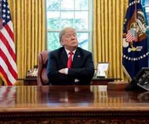 (FILES) In this file photo taken on October 10, 2018 US President Donald Trump speaks during a briefing on Hurricane Michael in the Oval Office of the White House in Washington, DC. - He came, he disrupted, he declared victory. Ask Donald Trump and he'll tell you 2018 was a roaring success.'Nobody's ever done a better job than I'm doing as president,' Trump told Washington Post journalist Bob Woodward. Classic Trump.Best ever or not, there's no denying this most unusual White House resident left quite a mark in the second year of his administration. (Photo by SAUL LOEB / AFP)