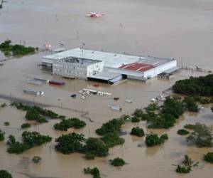 Aerial view of a factory in the municipality of La Lima, on the outskirts of San Pedro Sula, 240 km north of Tegucigalpa, flooded due to the overflowing of the Chamelecon river after the passage of Hurricane Iota, taken on November 18, 2020. - Storm Iota, which made landfall in Nicaragua as a 'catastrophic' Category 5 hurricane Monday, killed at least ten people as it smashed homes, uprooted trees and swamped roads during its destructive advance across Central America. (Photo by Orlando SIERRA / AFP)