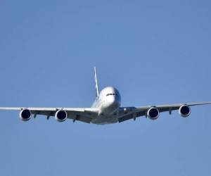 This picture taken on June 25, 2017 shows a 380 airbus Jumbo jet flying over the city of Saint-Nazaire, western France. (Photo by LOIC VENANCE / AFP)