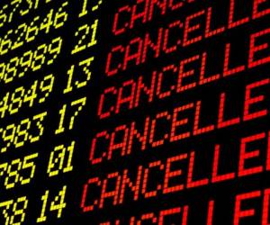 Cancelled flights on airport board panel