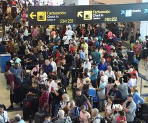 Passengers wait in long lines during a blackout at Tocumen International Airport in Panama City on September 18, 2017. - A blackout in Panama's main international airport -- a major hub for Latin America -- caused many flight cancelations and delays on Monday. A malfunction in a circuit panel distributing power internally to the facility was to blame, according to the airport authority, which had set up a 'crisis room' to handle the disruption. (Photo by Rodrigo ARANGUA / AFP)