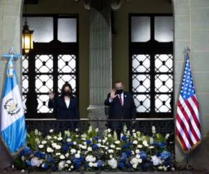 US Vice President Kamala Harris (L) and Guatemalan President Alejandro Giammattei wave at the Palacio Nacional de la Cultura in Guatemala City on June 7, 2021. (Photo by JIM WATSON / AFP)