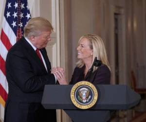 (FILES) In this file photo taken on October 12, 2017, US President Donald Trump clasps hands with Kirstjen Nielsen after nominating her to be the next Homeland Security Secretary in the East Room of the White House in Washington, DC. - US President Donald Trump on Sunday, April 7, 2019 announced Homeland Security Secretary Kirstjen Nielsen, the front-line defender of the administration's controversial immigration policies, would leave her position. 'Secretary of Homeland Security Kirstjen Nielsen will be leaving her position, and I would like to thank her for her service,' Trump tweeted. (Photo by MANDEL NGAN / AFP)
