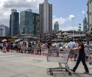 People wait for their turn to enter a supermarket in Panama City, on March 16, 2020, following the announcement by the Panamanian government to restrict access to 50 people per supermarket as a precautionary measure against the new coronavirus, COVID-19, pandemic. - Quarantine, schools, shops and borders closed, gatherings banned, are the main measures being taken in many countries across the world to fight the spread of the novel coronavirus. (Photo by Luis ACOSTA / AFP)