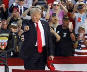 Former US President Donald Trump points to the crowd as he arrives for his campaign-style rally in Wellington, Ohio, on June 26, 2021. - Donald Trump held his first big campaign-style rally since leaving the White House, giving a vintage, rambling speech Saturday to an adoring audience as he launched a series of appearances ahead of next year's midterm elections.The former president, who has been booted from social media platforms and faces multiple legal woes, has flirted with his own potential candidacy in 2024, but in the 90-minute address at a fair grounds in Ohio he made no clear mention of his political future, even when the crowd chanted 'four more years! four more years!' (Photo by STEPHEN ZENNER / AFP)