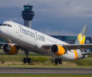 (FILES) In this file photo taken on July 12, 2019, pedestrians walk past a branch of a Thomas Cook travel agent's shop in London. - Thomas Cook's 178-year existence was hanging by a thread on Sunday after the iconic British travel firm struggled to find further private investment and is now relying on an unlikely government bailout. (Photo by Tolga Akmen / AFP)