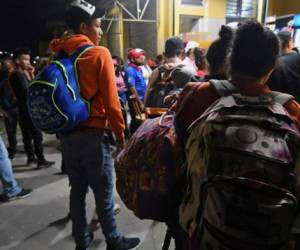 Honduran migrants gather at the Gran Central Metropolitana bus terminal, while waiting for the second caravan to leave to the United States, in San Pedro Sula, 180 km north of Tegucigalpa, on January 14, 2019. - President Donald Trump is threatening to declare a national emergency as he pressures Congress for money to build a wall on the US-Mexican border to stem a surge in illegal immigrants. Many migrants -who arrive as families or unaccompanied children, hoping to gain a foothold in the country- when caught, most are processed by the authorities, then released pending a court date, and authorities say they are mostly never seen again as they meld into US society. (Photo by ORLANDO SIERRA / AFP)