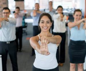 Business people on an active break at the office stretching and looking very happy - healthy lifestyle concepts