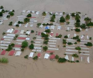 (FILES) In this file photo taken on November 18, 2020 Aerial view an area around San Pedro Sula, 240 km north of Tegucigalpa, flooded by the overflowing of the Chamelecon river after the passage of Hurricane Iota, taken on November 18, 2020. - Storm Iota, which made landfall in Nicaragua as a 'catastrophic' Category 5 hurricane Monday, killed at least ten people as it smashed homes, uprooted trees and swamped roads during its destructive advance across Central America. (Photo by Orlando SIERRA / AFP)