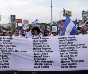 Members of the Mothers of April movement take part in a protest demanding justice for their sons who died during the recent protests following an attempt by President Daniel Ortega to reform the near-bankrupt social security system, at the Ruben Dario roundabout in Managua on May 10, 2018. / AFP PHOTO / Diana Ulloa