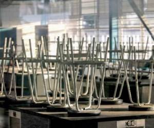 Picture of an empty classroom at the University Centre for Economic-Administrative Sciences (CUCEA) of the University of Guadalajara (UAG), in Guadalajara, Jalisco State, Mexico, taken on March 17, 2020 after classes at all levels in Mexico were suspended for an indefinite period as a precautionary measure against the spread of the new coronavirus, COVID-19. - Quarantine, schools, shops and borders closed, gatherings banned, are the main measures being taken in many countries across the world to fight the spread of the novel coronavirus. (Photo by Ulises Ruiz / AFP)