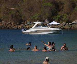 <i>Turistas se bañan en la playa de la isla Taboga en la ciudad de Panamá, el 30 de marzo de 2024.FOTO MARTÍN BERNETTI / AFP</i>