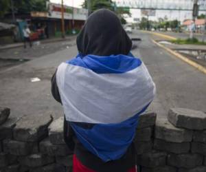 A peasant who spent the night at the Metropolitan Cathedral in Managua, where he took refuge during deadly clashes within a march marking Nicaragua's National Mothers Day, is pictured after leaving the church on May 31, 2018. The death toll from weeks of violent unrest in Nicaragua rose to almost 100 as embattled President Daniel Ortega rejected calls to step down and the Catholic church, which has tried to mediate the conflict, Thursday refused to resume the dialogue. / AFP PHOTO / INTI OCON