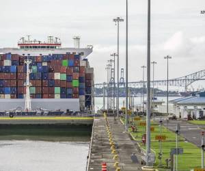 <i>Un carguero navega por el Canal de Panamá en el área de las Esclusas de Cocolí, en la Ciudad de Panamá, el 25 de agosto de 2023. El Canal de Panamá, afectado por la sequía, mantendrá restricciones al paso de barcos durante un año. FOOTO IVÁN PISARENKO / AFP</i>