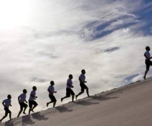 mutiple shot of same person running in sand