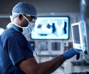 Shot of a surgeon looking at a monitor in an operating room