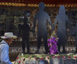 An man walks past the memorial to the victims of the El Mozote massacre, in the village of El Mozote, 200 km east of San Salvador, on August 30, 2018. Judges of the Inter-American Court of Human Rights (IACHR), whose 59 special session is being held in El Salvador, moved to El Mozote to supervise the compliance with the redress ruled for the largest massacre in recent history in Latin America, in which almost a thousand people were executed by the army in 1981. / AFP PHOTO / Oscar Rivera