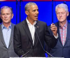 (FILES) In this file photo taken on October 21, 2017, (L-R) George W. Bush, Barack Obama and Bill Clinton attend the Hurricane Relief concert in College Station, Texas. - Obama, Bush and Bill Clinton are volunteering to take a coronavirus vaccine on camera if it will help promote public confidence. Obama, in an interview with SiriusXM radio, said he would be inoculated if top US infectious disease expert Anthony Fauci signs off on a Covid-19 vaccine. Freddy Ford, Bush's chief of staff, told CNN the former president also wanted to help promote vaccination. Angel Urena, Clinton's press secretary, told CNN the former president would also be willing to take a vaccine in public on television. (Photo by JIM CHAPIN / AFP)
