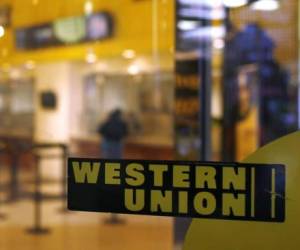 JORDAN, HONG KONG, KOWLOON - 2018/03/21: Pedestrian walks by a Western Union branch in Tsim Sha Tsui.Hong Kong is a city with 7.5 million population in 2017, it was a British Crown colony until 1997 and since then the sorvidenty was being handed back the People's Republic of China. (Photo by Miguel Candela/SOPA Images/LightRocket via Getty Images)