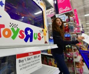 (FILES) This file photo taken on December 19, 2017 shows a woman shopping at a Toys R Us store in Alhambra, California.Toys 'R' US plans to sell or close all of its US stores, potentially hitting 33,000 jobs, US media reported on March 14, 2018. / AFP PHOTO / FREDERIC J. BROWN