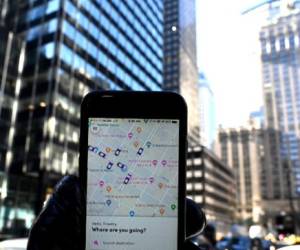 An iPhone with the Lyft ride-sharing app on it shows cars in the area on Park Avenue in New York City March 26, 2019. - Lyft Inc.'s initial public offering is expected to have its (IPO) this week making it the first of the ride-hailing companies to open up to the public. (Photo by TIMOTHY A. CLARY / AFP)