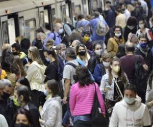 Sofia, Bulgaria - June 23 2020: Subway train passengers with protective masks crowding to get on and off subway station platform on Serdika Metro station.