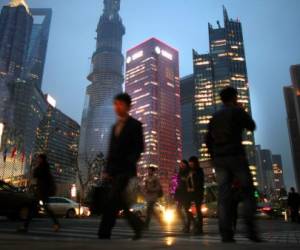 In a global survey, many respondents believe that China has overtaken or eventually will overtake the U.S. as the world's leading superpower. Chinese are shown here walking in Shanghai's financial district in March.