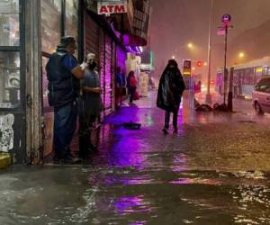 NEW YORK, NY - SEPTEMBER 01: People make their way in rainfall from the remnants of Hurricane Ida on September 1, 2021, in the Bronx borough of New York City. The once category 4 hurricane passed through New York City, dumping 3.15 inches of rain in the span of an hour at Central Park. (Photo by David Dee Delgado/Getty Images)