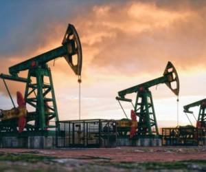 Working oil pumps against a sunset sky.