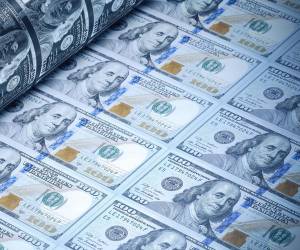 One hundred American dollars being printed. Selective focus. Horizontal composition with copy space. Money printing concept.